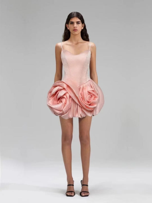 Pink dress with floral design worn by a model on a gray background