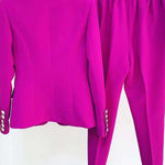 Purple suit jacket and pants on a white background