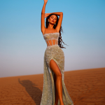 Woman posing in a slit corset gown in the desert