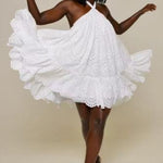 Woman in eyelet halter dress dancing