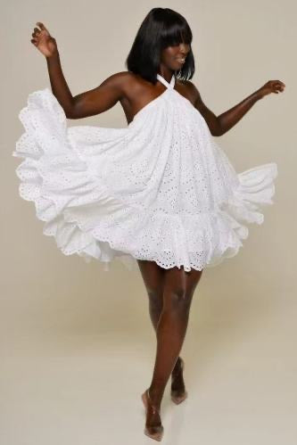 Woman in eyelet halter dress dancing
