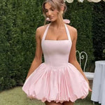 Woman wearing a halter bubble mini dress outdoors