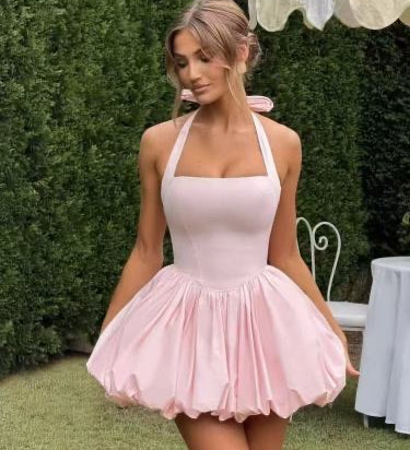 Woman wearing a halter bubble mini dress outdoors