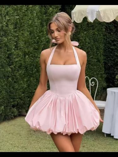 Woman wearing a halter bubble mini dress outdoors