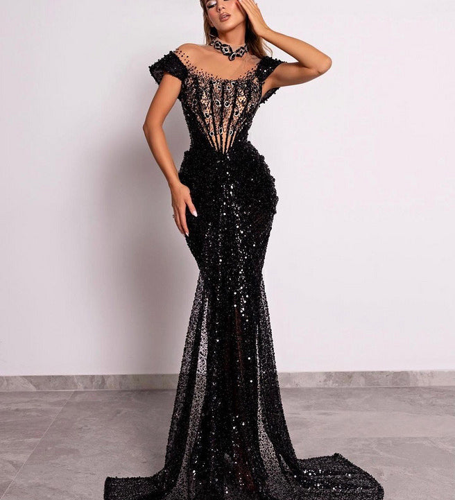 Model in sequin corset gown with cap sleeves