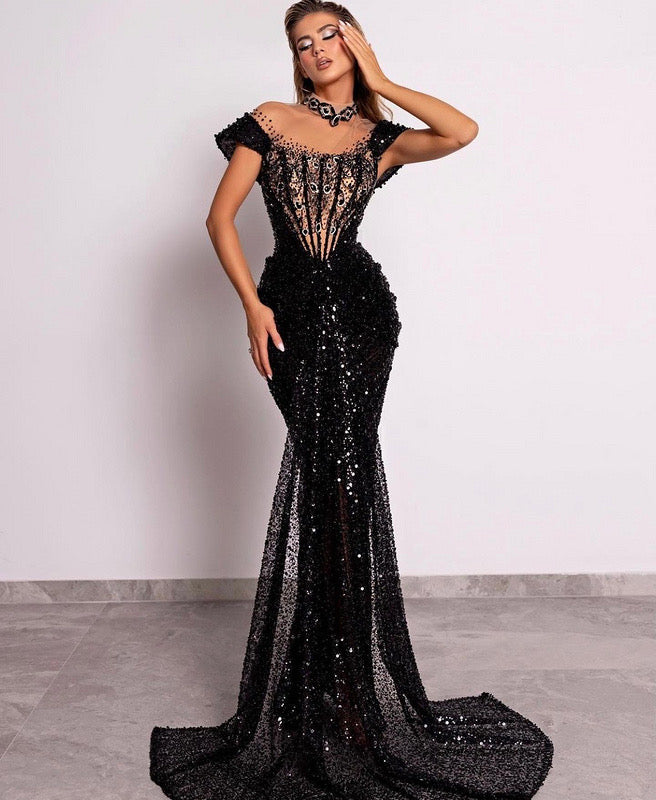 Model in sequin corset gown with cap sleeves