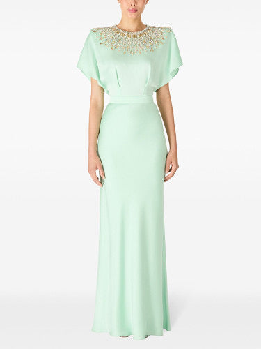 Woman in cape-sleeve gown with beaded neckline